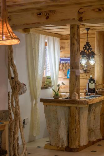 a kitchen with a counter in a room with wooden ceilings at Rustic Lodge Plitvice in Plitvička Jezera