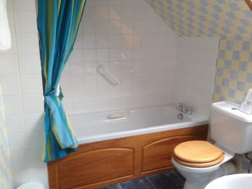 a bathroom with a tub and a toilet and a sink at Creag Na Mara B&B in Thurso