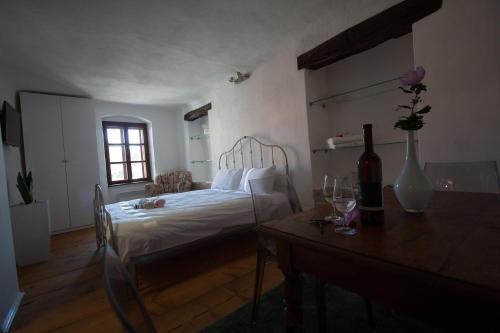 a bedroom with a bed and a table with a vase at Vestonicka Moruse in Dolní Věstonice