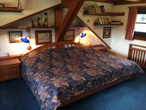 a bedroom with a bed with a blue carpet at CHATA Privlaky in Přívlaky