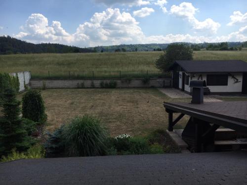 a backyard with a picnic table and a field at CHATA Privlaky in Přívlaky