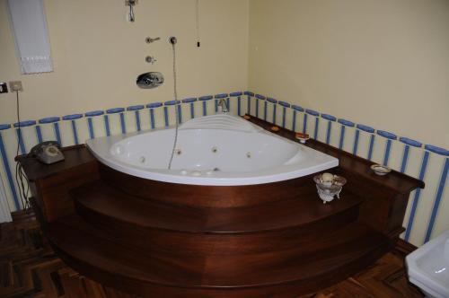 a bath tub in a bathroom with a wooden floor at A Casa di Teresa in Trecchina