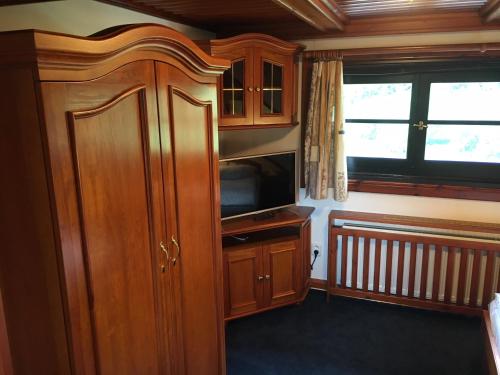 a kitchen with wooden cabinets and a microwave at CHATA Privlaky in Přívlaky