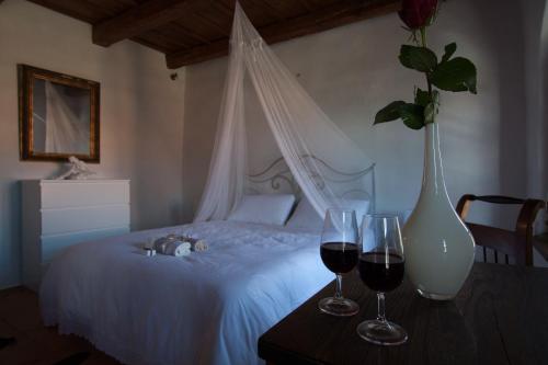 a bedroom with a bed with two glasses of wine at Vestonicka Moruse in Dolní Věstonice