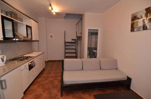 a living room with a couch in a kitchen at Penelope Apartment Hotel in Dassia