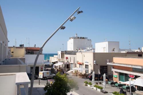 a street light in a city with buildings at Hotel Morini in San Foca