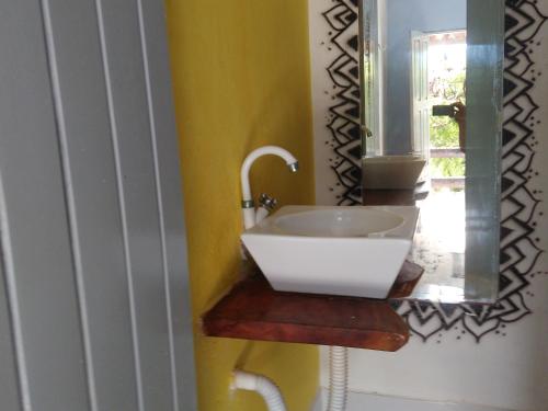 a bathroom with a sink and a mirror at Blue Day in Canoa Quebrada