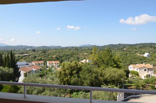 a view of a town from the balcony of a house at Penelope Apartment Hotel in Dassia