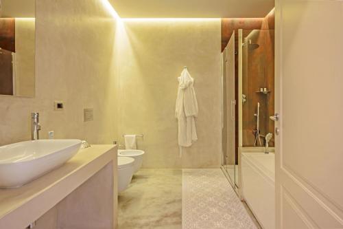 a bathroom with a sink and a toilet and a shower at SUYTE Torino Centro in Turin