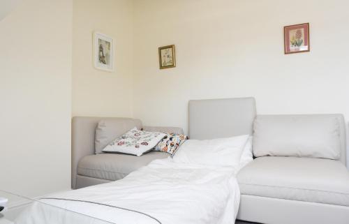 a white living room with a couch and a bed at Dale Street Apartments Suite in Leamington Spa