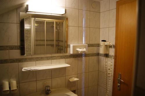 a bathroom with a sink and a mirror at Der Oswalderhof in Obertilliach