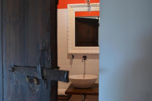 a bathroom with a white sink and a mirror at Fattoria Bio L'A Ceccoli in Sassofeltrio