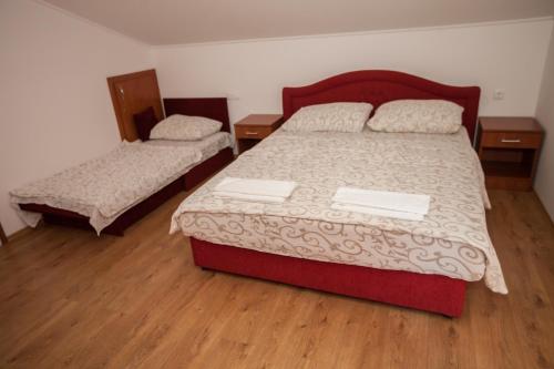 a bedroom with two beds and two night stands at Ninkovic in Trebinje