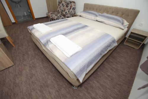 a large bed with two pillows on it in a room at Ninkovic in Trebinje