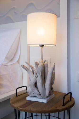 a table with a lamp on top of it at Elenis Philoxenia in Ixia