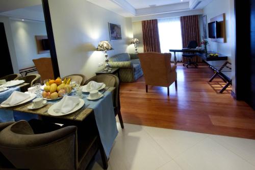 a living room with a table with fruit on it at Hotel Elizabeth Cebu in Cebu City