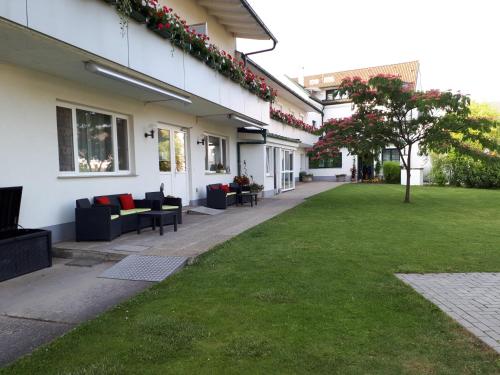a courtyard of a building with a green lawn at Pension Joseph Haydn in Podersdorf am See