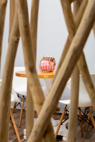 a table with white chairs and a red pillow on it at Elenis Philoxenia in Ixia