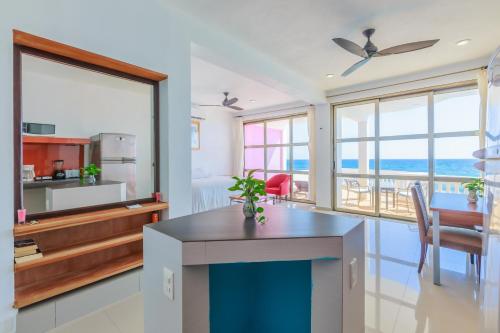 a kitchen and dining room with a view of the ocean at Villa Elena Isla Mujeres in Isla Mujeres
