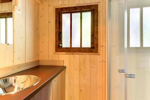 a bathroom with a sink and a window at Cabanes Lodges Le Servière in Balazuc