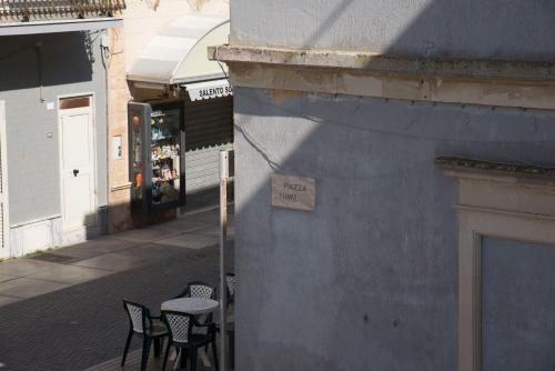 a table and chairs on a sidewalk next to a building at Hotel Morini in San Foca