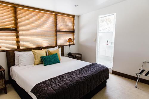 a bedroom with a large bed and a window at The Narrows Landing Hotel in Hamilton