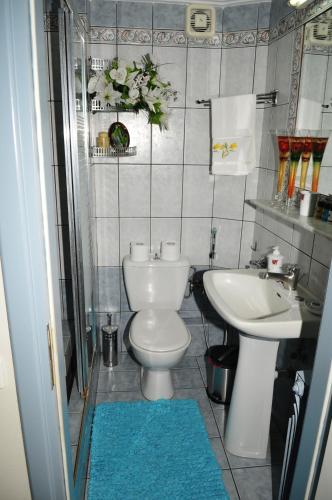 a bathroom with a white toilet and a sink at Giorgos-Vera in Kavála