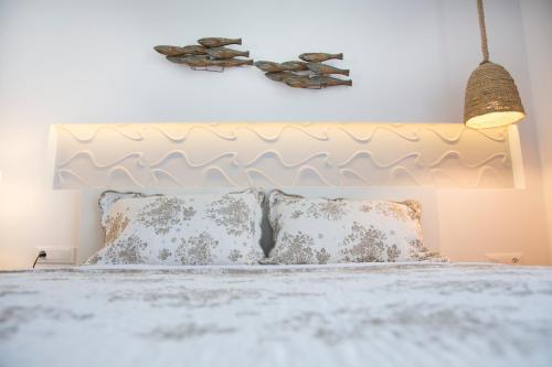 a bedroom with a bed with a white headboard at Elenis Philoxenia in Ixia