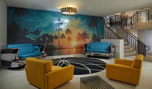 a living room with a mural of palm trees and cars at Hard Rock Hotel Daytona Beach in Daytona Beach