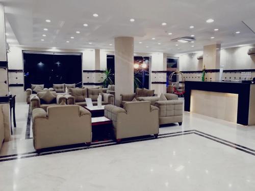 a large living room with couches and a bar at Nafal Hotel Suites in Qal'at Bishah