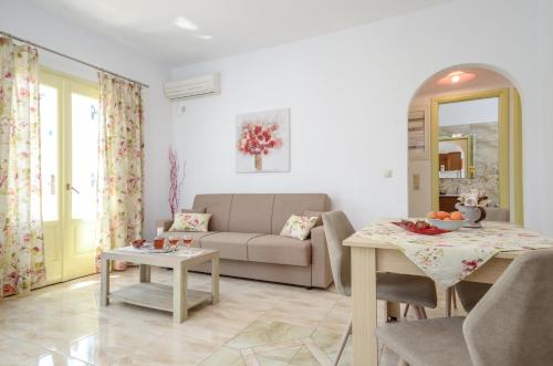 a living room with a couch and a table at Kapris House in Agios Prokopios