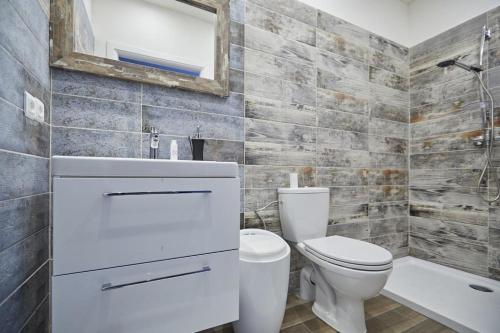 a bathroom with a toilet and a sink and a mirror at Saska Kępa Apartamenty in Warsaw