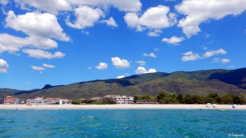a view of a beach with mountains in the background at Medusa Beach Apartment, Asprovalta in Asprovalta
