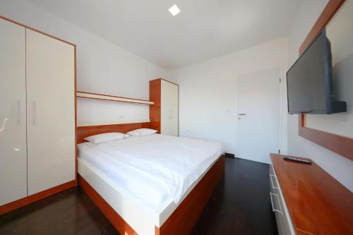 Posteľ alebo postele v izbe v ubytovaní Apartmani Postimana