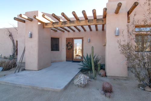 an entrance to a house with a wooden pergola at Borrego Valley Inn in Borrego Springs