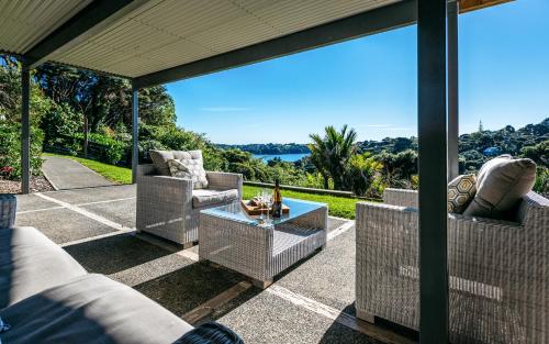 an outdoor patio with couches and a table at Wild Thyme in Oneroa