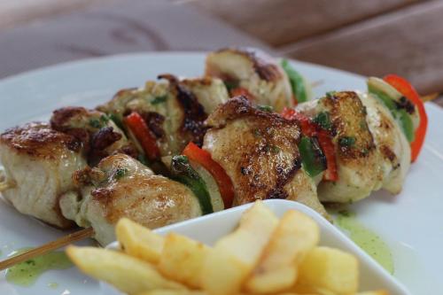 a plate of food with chicken and vegetables and fries at Cartagena Royal Hotel Boutique in Cartagena de Indias