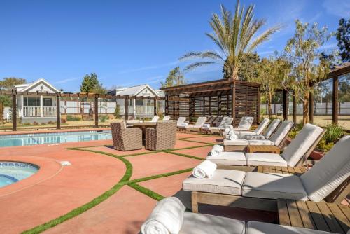 a patio with lounge chairs and a swimming pool at Flying Flags RV Resort & Campground in Buellton