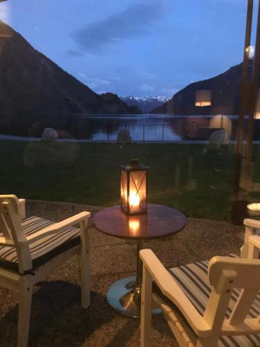 a lantern sitting on a table next to two chairs at Sogn Hotel in Vadheim