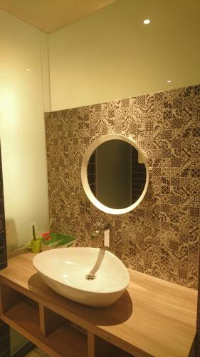 a bathroom with a white sink and a mirror at Travel Port Motel in Kaohsiung