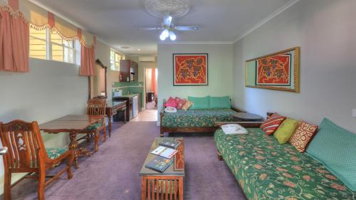 a living room with a couch and a table at Hatchers Richmond Manor in Richmond