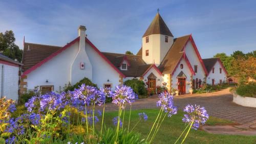 a large white building with a church with purple flowers at Hatchers Richmond Manor in Richmond