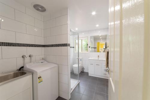 a white bathroom with a sink and a toilet at Tokemata Retreat in Cobram