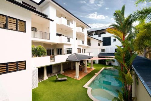 a house with a patio and a pool at Cairns City Apartments in Cairns