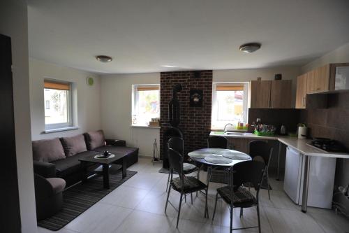 a living room and kitchen with a couch and a table at Mazurskiewczasy in Kruklanki