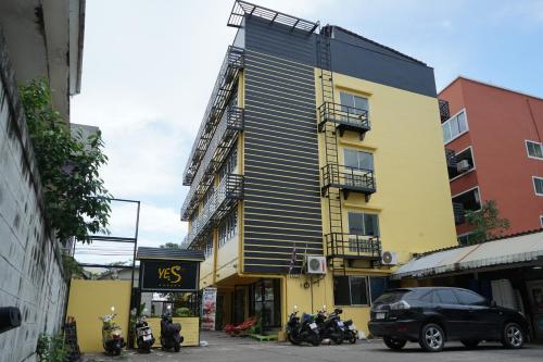 a yellow and black building with motorcycles parked in front of it at Yes Kaosan in Bangkok