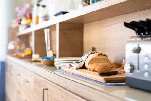 a loaf of bread on a cutting board in a kitchen at MARCONI 1935 in Follonica