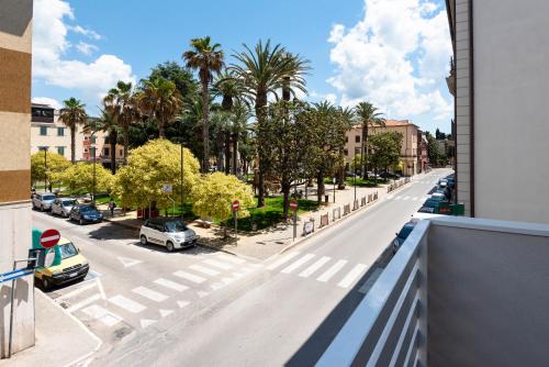 a view from a balcony of a street with palm trees at MARCONI 1935 in Follonica