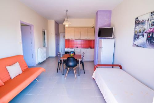 a living room with a couch and a table at Voula Apartments in Mitikas
