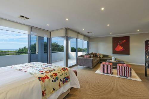 a bedroom with a bed and a couch in a room at The Bay Residence, Dunsborough WA in Quindalup